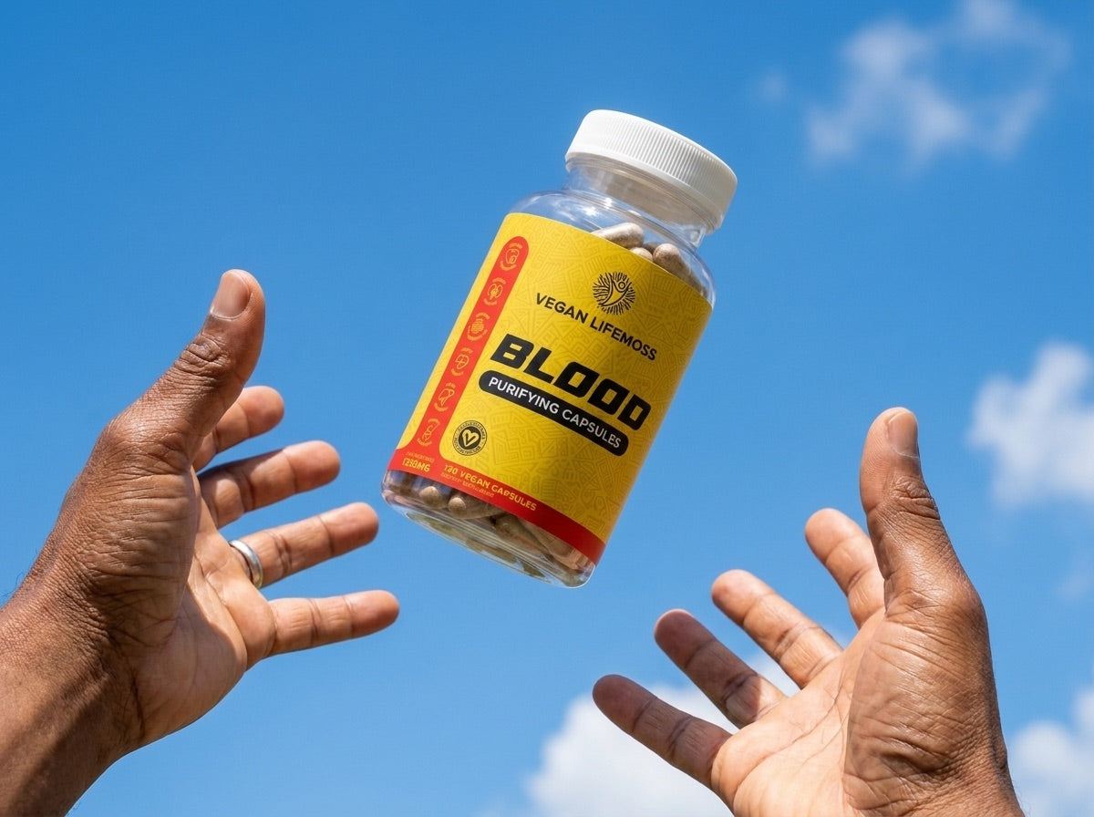 Two hands reaching for a bottle of Blood Purifying Capsules against a blue sky